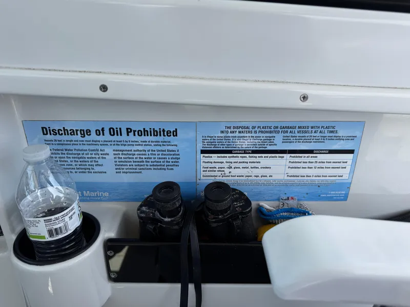 Slide: The Image of 2004 Glacier Bay 2680 Coastal Runner with oil discharge prohibition sign and plastic bottle. - 12