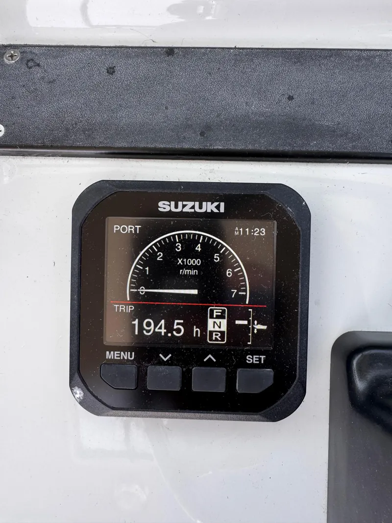 Slide: The Image of Suzuki boat gauge displaying 194.5 hours on a 2004 Glacier Bay 2680 Coastal Runner. - 18
