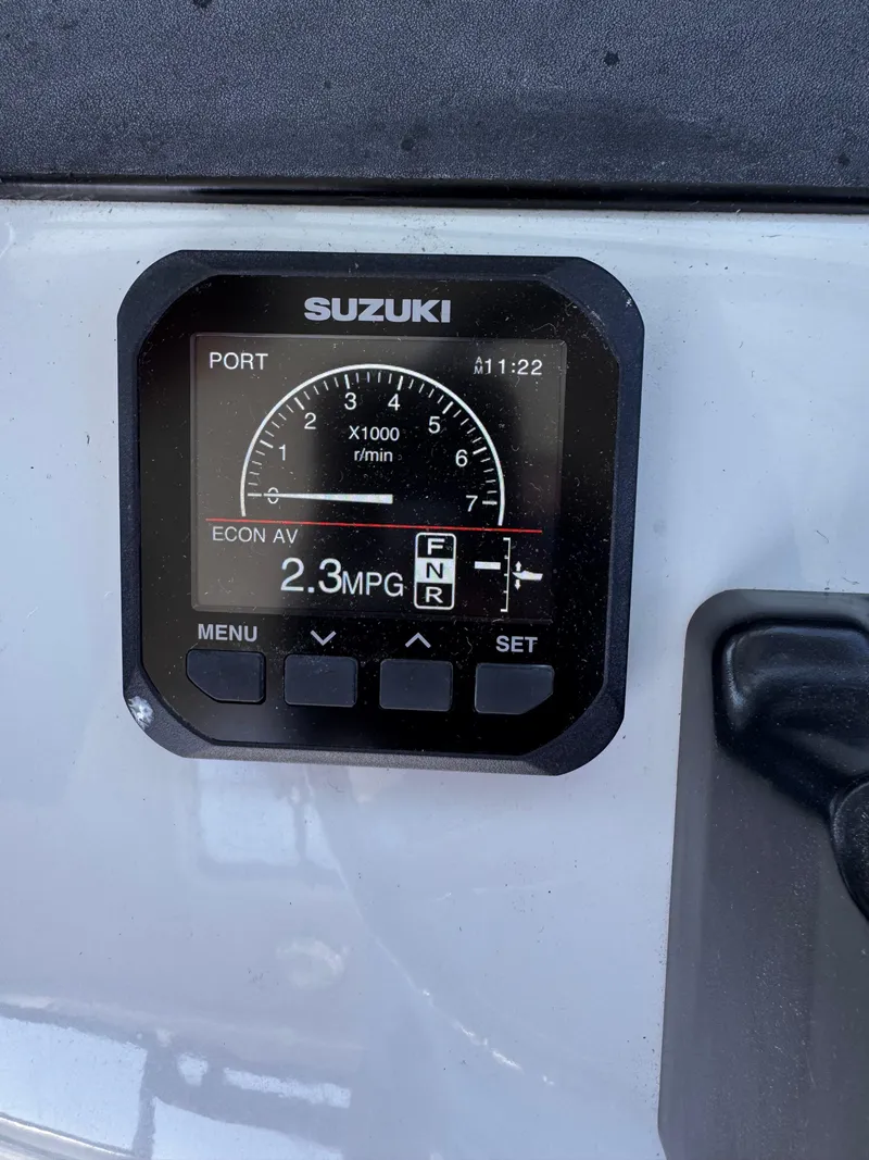 Slide: The Image of Suzuki boat gauge displaying 2.3 MPG on a 2004 Glacier Bay 2680 Coastal Runner. - 19