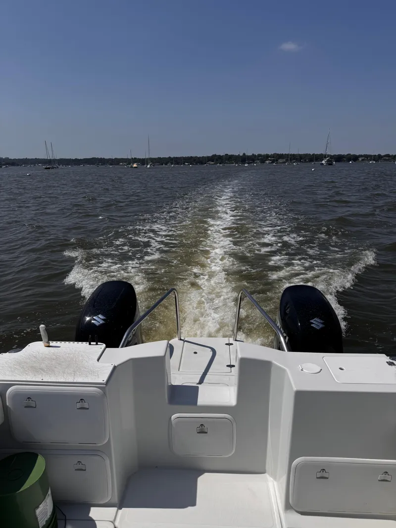 Slide: The Image of 2004 Glacier Bay 2680 Coastal Runner on water, view from stern, twin engines visible. - 27