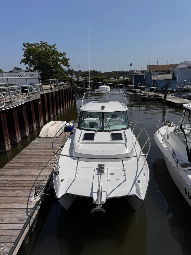 Slide: The Image of 2004 Glacier Bay 2680 Coastal Runner docked at marina, front view. - 3