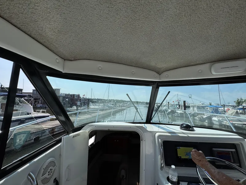 Slide: The Image of Interior view of 2004 Glacier Bay 2680 Coastal Runner at marina dock. - 34