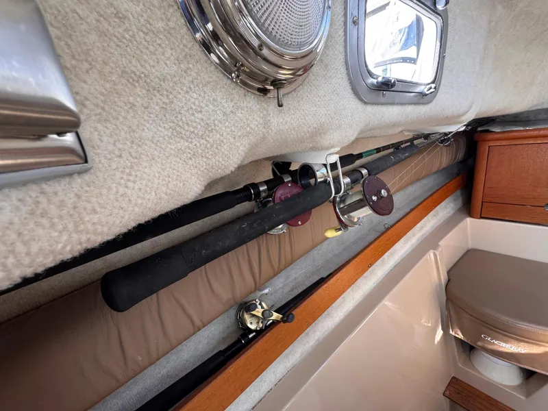 Slide: The Image of Interior of 2004 Glacier Bay 2680 Coastal Runner with fishing rods and seating. - 37