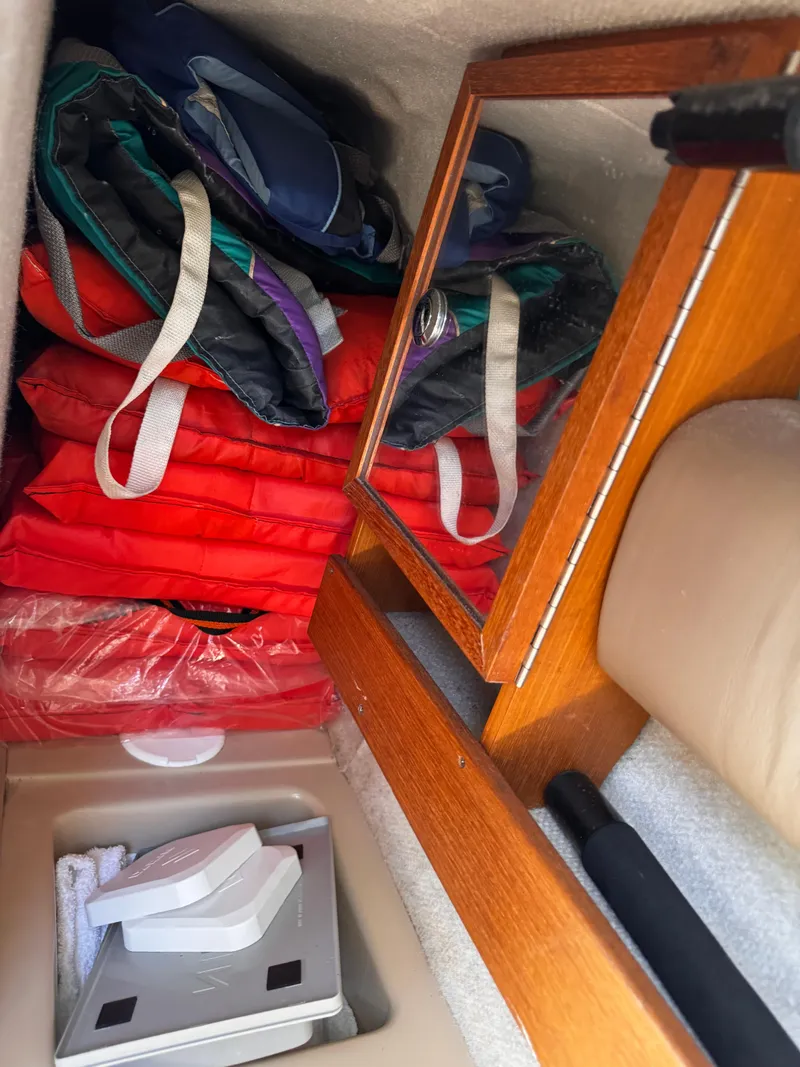 Slide: The Image of Storage area in a 2004 Glacier Bay 2680 Coastal Runner with life jackets and wooden cabinet. - 38