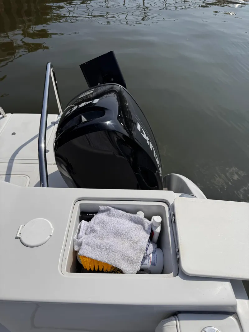 Slide: The Image of 2004 Glacier Bay 2680 Coastal Runner with outboard motor and storage compartment. - 40