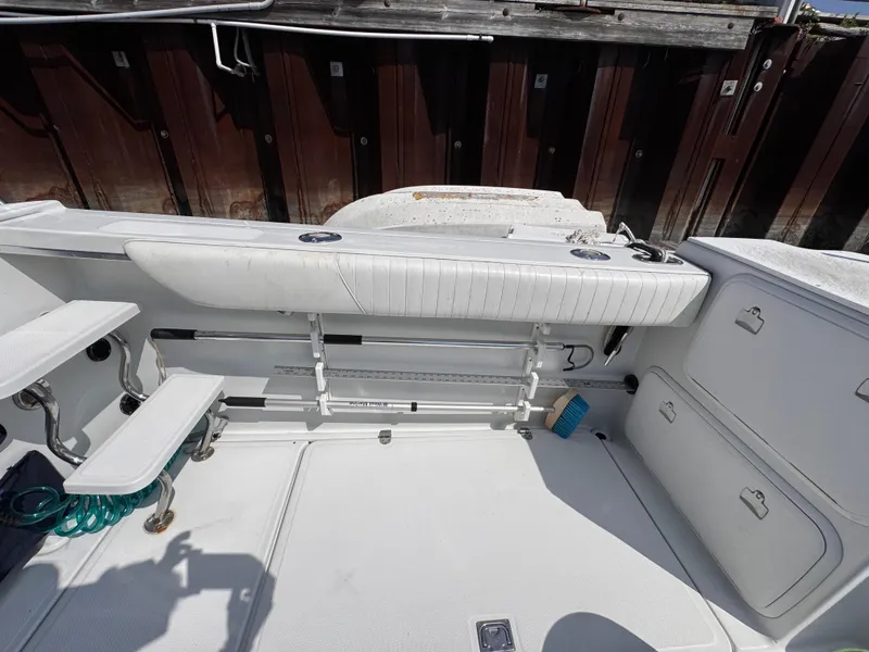 Slide: The Image of 2004 Glacier Bay 2680 Coastal Runner boat interior with seating and storage compartments. - 41