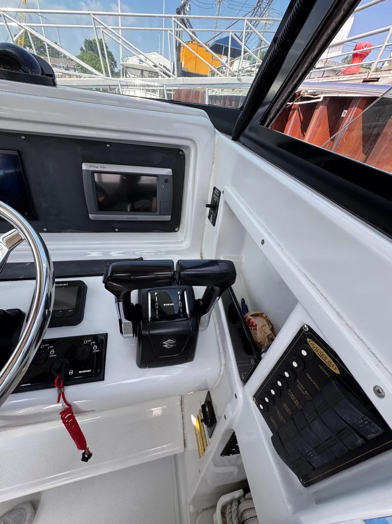 Slide: The Image of 2004 Glacier Bay 2680 Coastal Runner cockpit with controls and navigation equipment. - 44