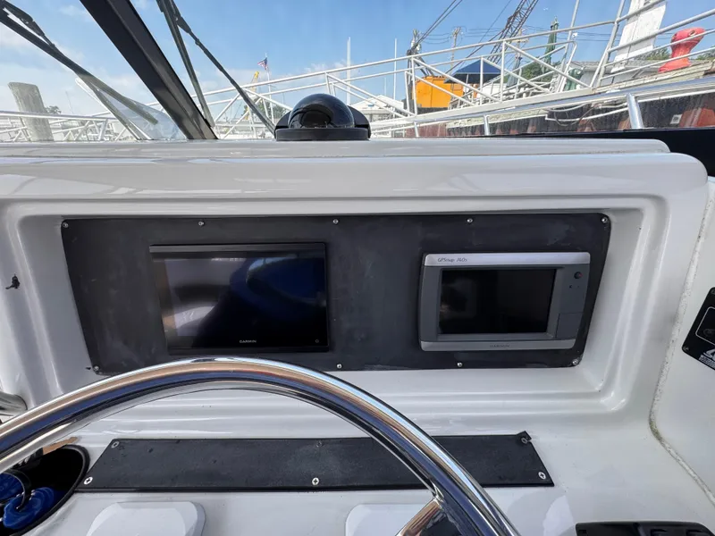 Slide: The Image of 2004 Glacier Bay 2680 Coastal Runner dashboard with Garmin navigation displays. - 46