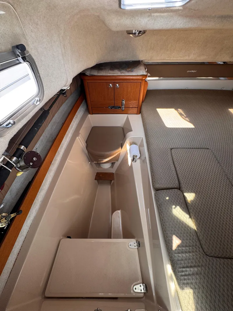 Slide: The Image of 2004 Glacier Bay 2680 Coastal Runner cabin interior with seating and storage. - 48