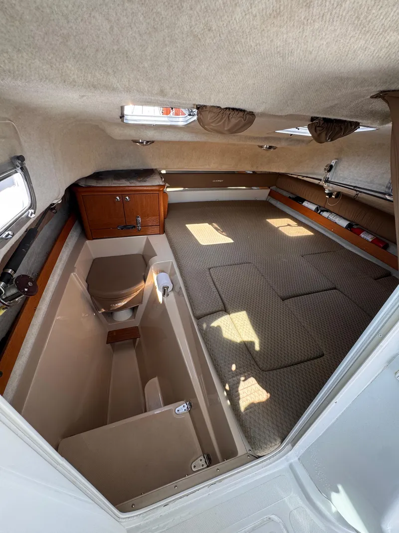 Slide: The Image of Interior of 2004 Glacier Bay 2680 Coastal Runner boat, featuring cabin and storage. - 49
