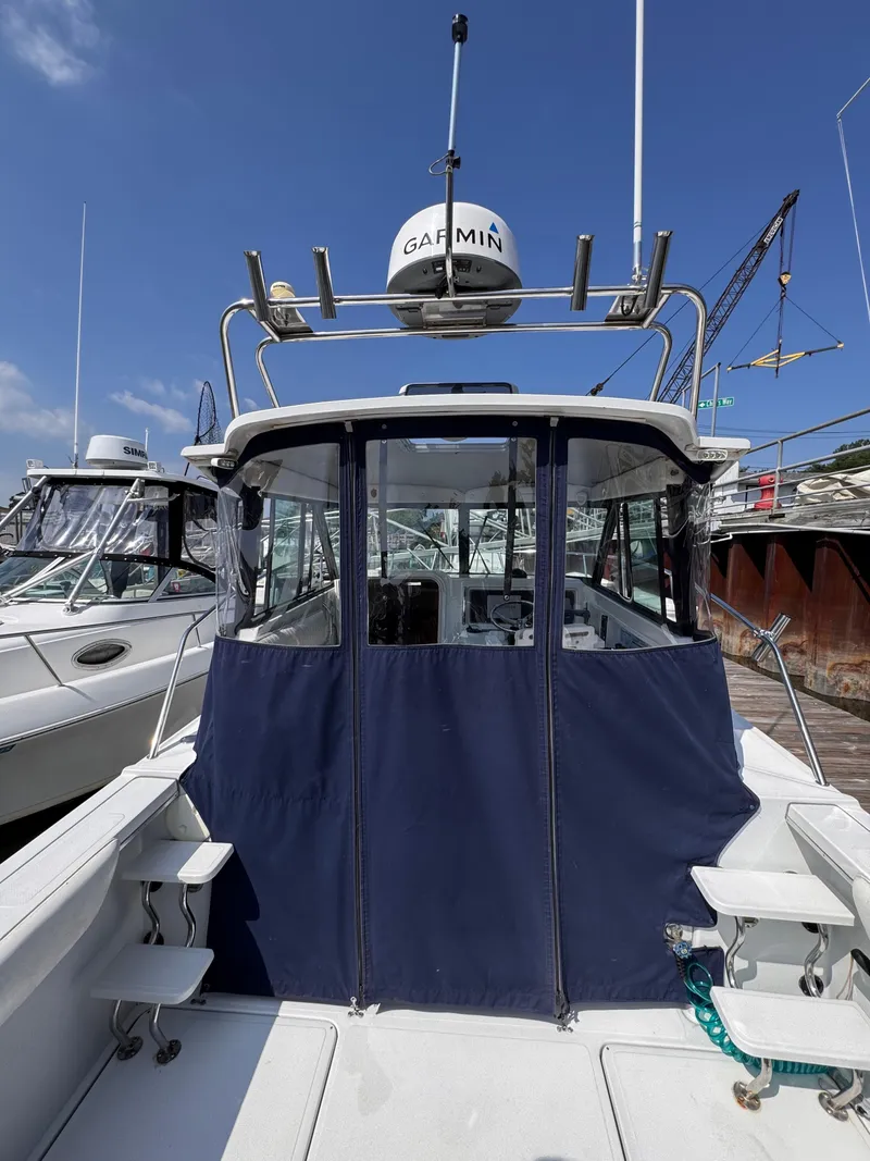 Slide: The Image of 2004 Glacier Bay 2680 Coastal Runner boat docked with Garmin radar. - 7