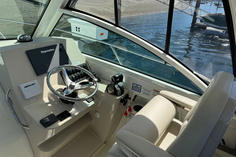 Slide: The Image of 2018 Boston Whaler 285 Conquest helm with Raymarine navigation and Mercury controls. - 15
