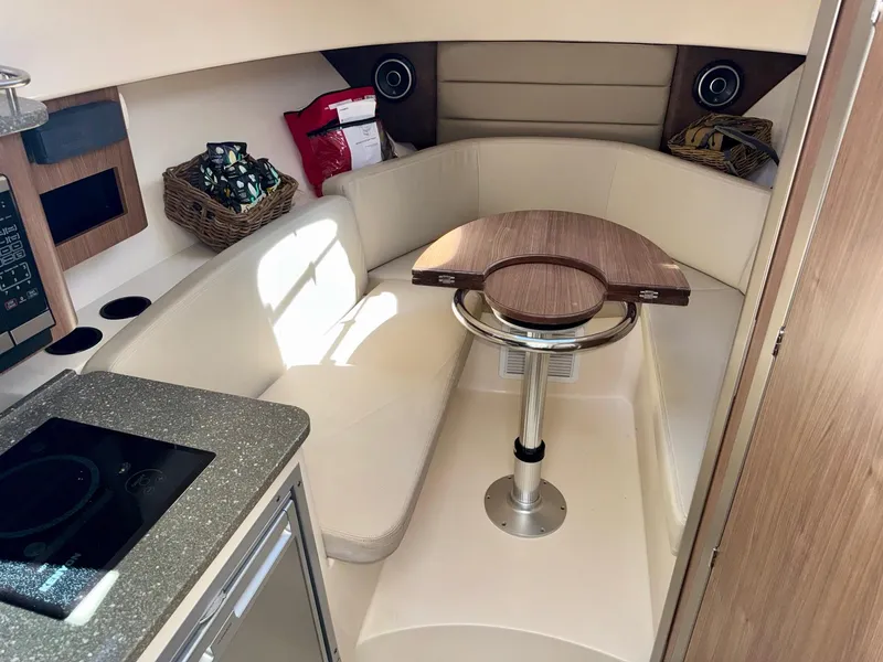 Slide: The Image of 2018 Boston Whaler 285 Conquest cabin interior with seating and table. - 19