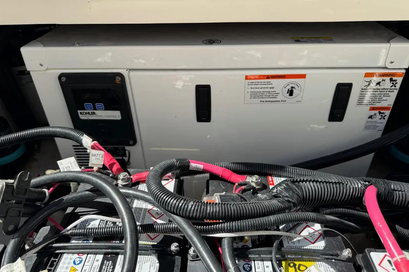 Slide: The Image of 2018 Boston Whaler 285 Conquest engine compartment with Kohler generator and wiring. - 28