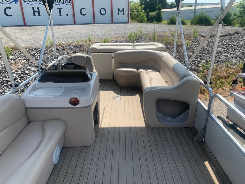 Slide: The Image of 2006 Sun Tracker PARTY BARGE 21 Signature Series interior with beige seating and helm. - 10