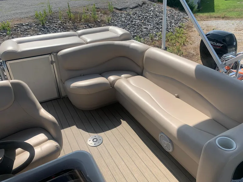 Slide: The Image of 2006 Sun Tracker PARTY BARGE 21 Signature Series with beige seating and Mercury outboard motor. - 11