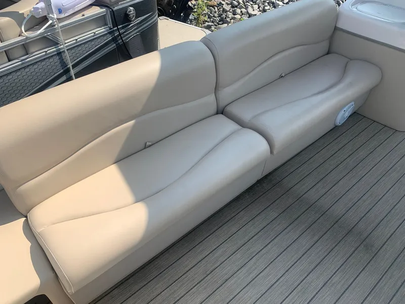 Slide: The Image of 2006 Sun Tracker PARTY BARGE 21 Signature Series boat seating, beige upholstery, and deck flooring. - 12