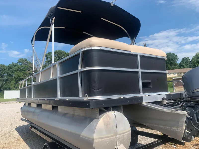 Slide: The Image of 2006 Sun Tracker PARTY BARGE 21 pontoon boat with canopy, parked outdoors. - 2