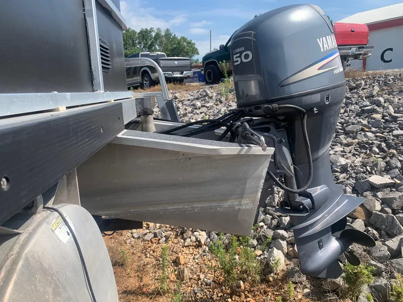 Slide: The Image of 2006 Sun Tracker PARTY BARGE 21 with Yamaha 50 outboard motor on rocky terrain. - 4