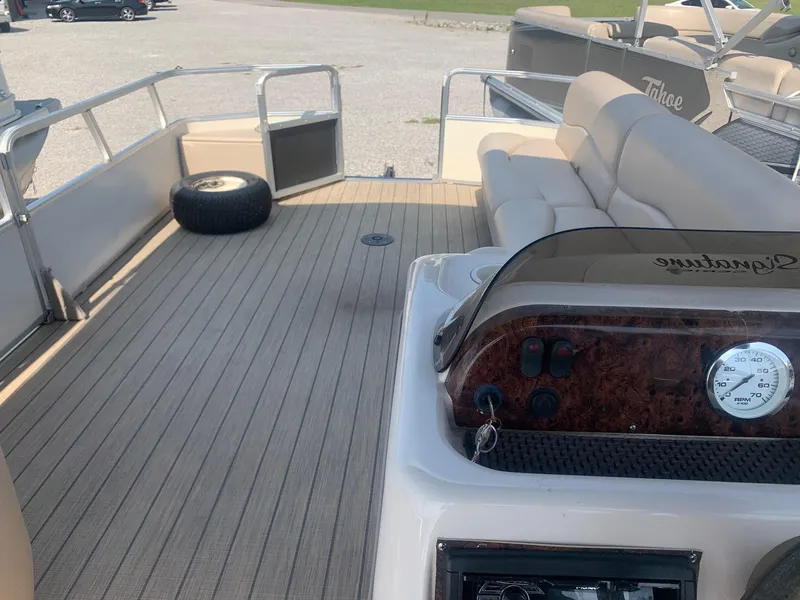 Slide: The Image of 2006 Sun Tracker PARTY BARGE 21 Signature Series interior with seating and dashboard view. - 6