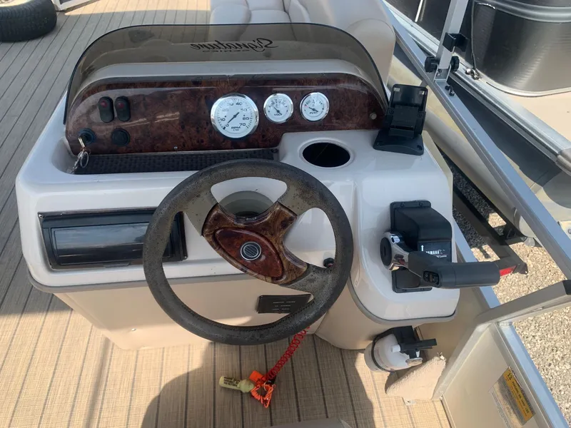 Slide: The Image of 2006 Sun Tracker PARTY BARGE 21 Signature Series boat dashboard with steering wheel and controls. - 8