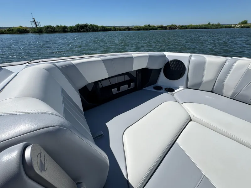 Slide: The Image of Interior of 2022 Malibu Wakesetter 24 MXZ boat with luxurious seating by the water. - 10