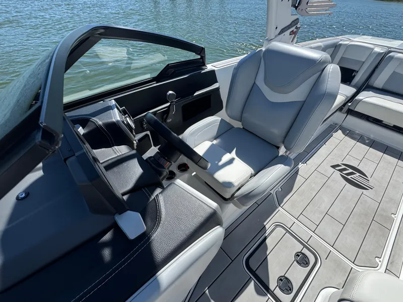 Slide: The Image of 2022 Malibu Wakesetter 24 MXZ interior with sleek seating and modern dashboard. - 13