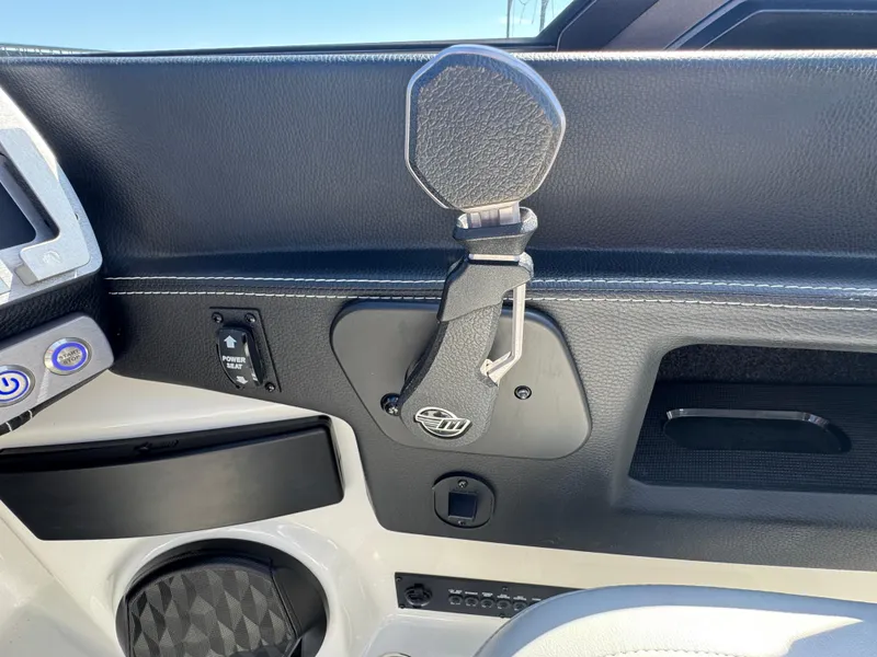 Slide: The Image of Interior detail of 2022 Malibu Wakesetter 24 MXZ boat, featuring controls and cup holder. - 14