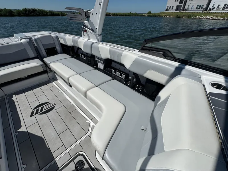 Slide: The Image of 2022 Malibu Wakesetter 24 MXZ interior with sleek seating and lake view. - 16