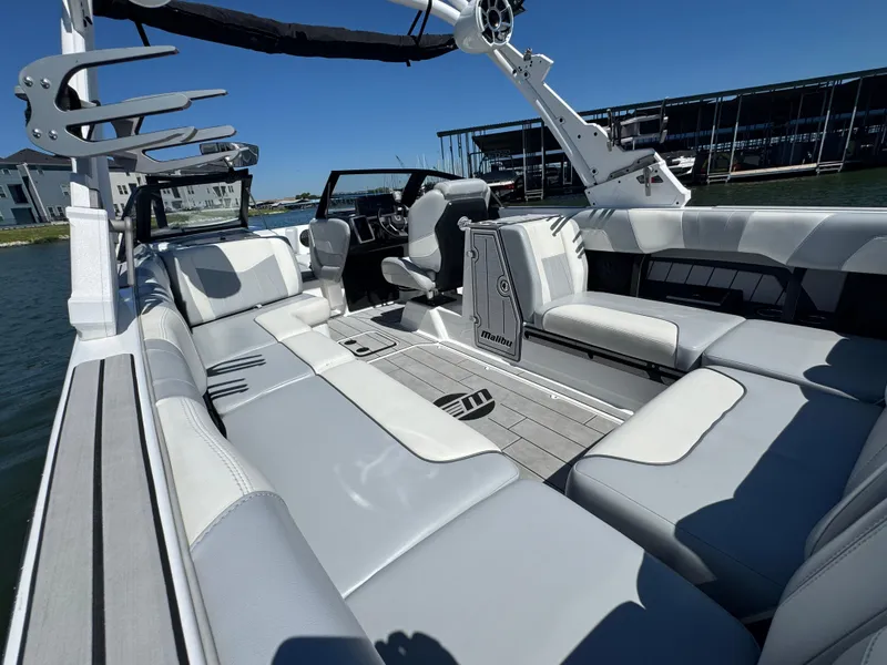 Slide: The Image of 2022 Malibu Wakesetter 24 MXZ boat interior with luxurious seating and sleek design. - 21