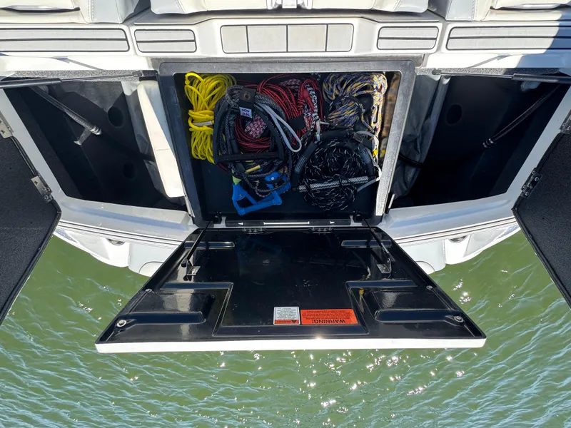 Slide: The Image of Storage compartment of 2022 Malibu Wakesetter 24 MXZ with ropes and equipment. - 23