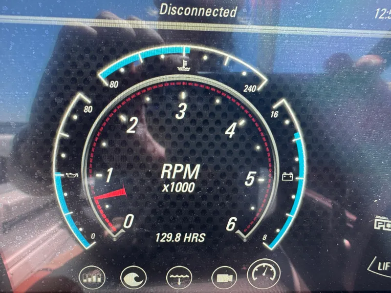 Slide: The Image of Dashboard of 2022 Malibu Wakesetter 24 MXZ showing RPM and engine hours. - 24