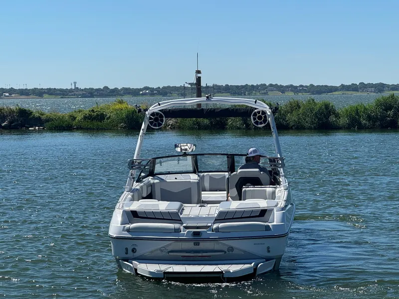 Slide: The Image of 2022 Malibu Wakesetter 24 MXZ boat on a sunny lake. - 3