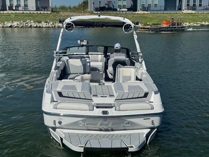 Slide: The Image of 2022 Malibu Wakesetter 24 MXZ on water, rear view with seating and speakers. - 6