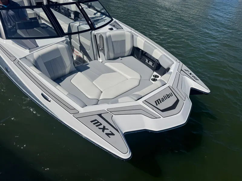 Slide: The Image of 2022 Malibu Wakesetter 24 MXZ boat with sleek design on calm water. - 8