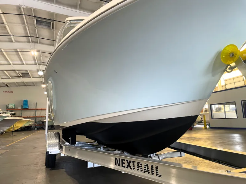 Slide: The Image of 2023 Key West 239 DFS with Yamaha outboard motor in a boat showroom. - 10