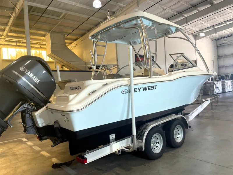 Slide: The Image of 2023 Key West 239 DFS boat on trailer in indoor storage facility. - 14