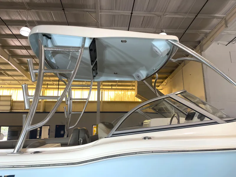 Slide: The Image of 2023 Key West 239 DFS boat with T-top and seating, displayed indoors. - 16