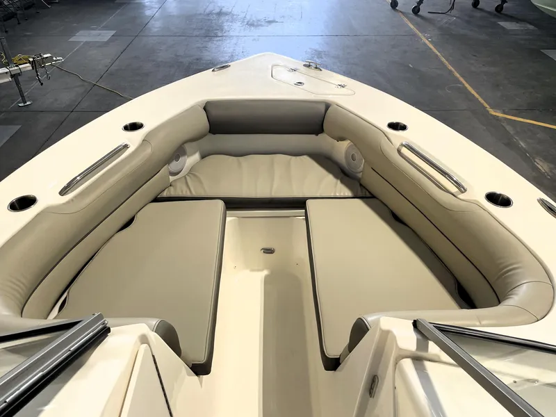 Slide: The Image of 2023 Key West 239 DFS boat interior with cushioned seating and cup holders. - 18