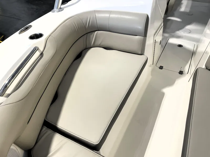 Slide: The Image of 2023 Key West 239 DFS boat interior with beige seating and cup holders. - 19