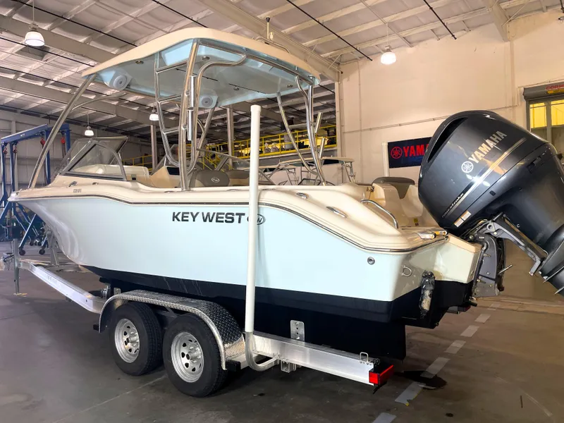 Slide: The Image of 2023 Key West 239 DFS boat with Yamaha engine in a warehouse. - 2