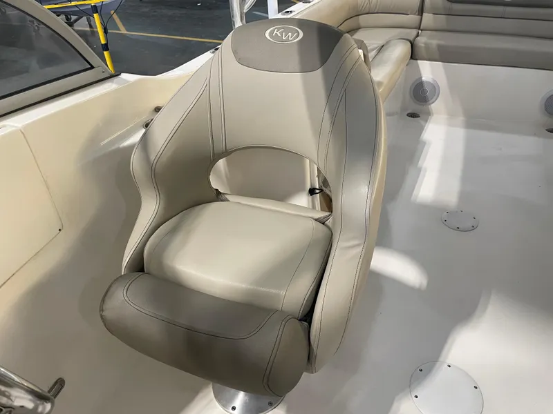 Slide: The Image of 2023 Key West 239 DFS boat seat with beige upholstery and KW logo. - 24