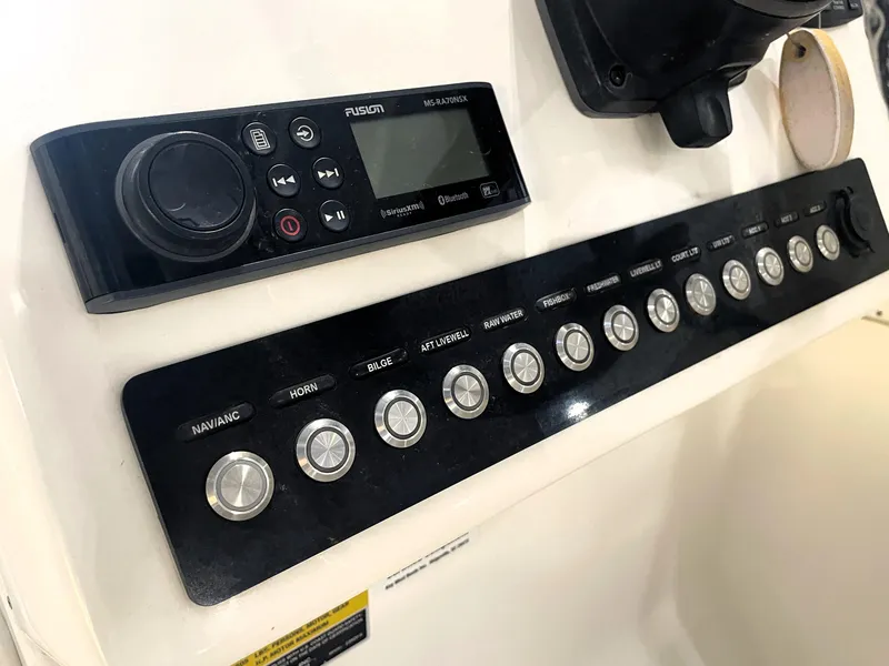 Slide: The Image of Control panel of 2023 Key West 239 DFS boat with buttons and audio system. - 26