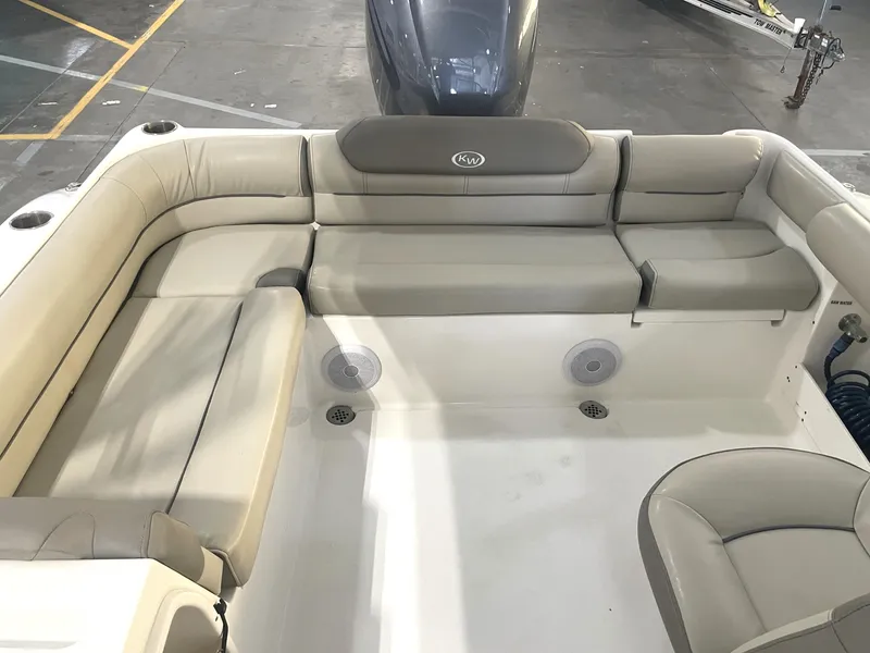Slide: The Image of 2023 Key West 239 DFS boat interior with beige seating and speakers. - 33