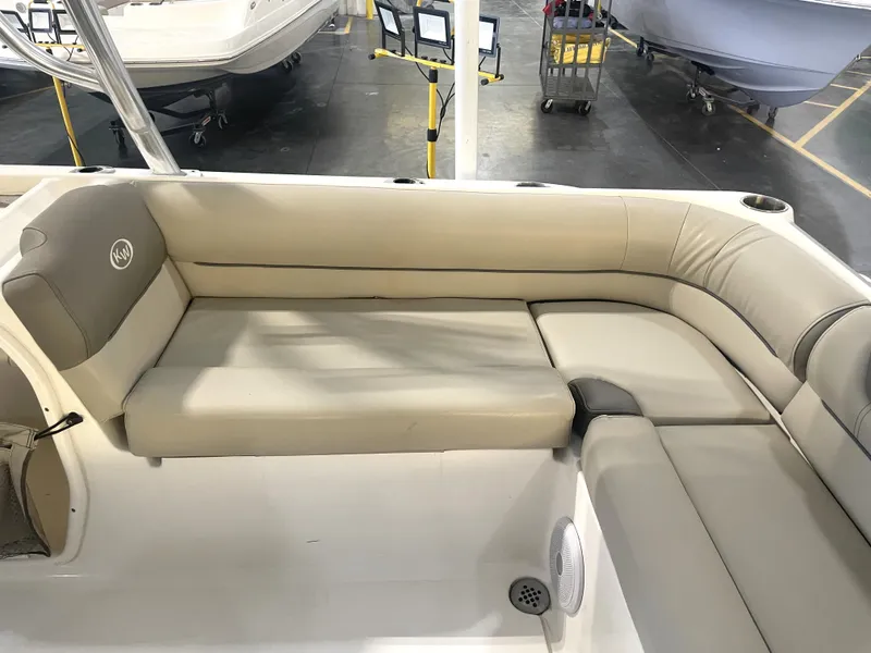Slide: The Image of 2023 Key West 239 DFS boat interior with beige seating and cup holders. - 34