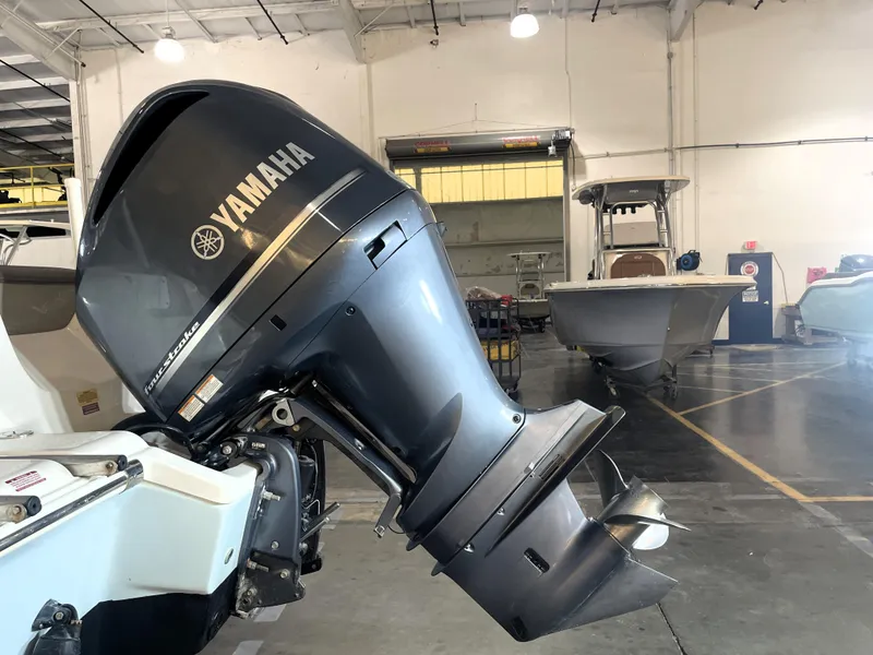 Slide: The Image of 2023 Key West 239 DFS boat with Yamaha engine in a warehouse setting. - 7