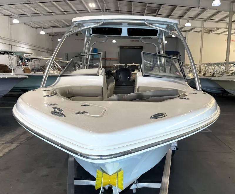 Slide: The Image of 2023 Key West 239 DFS boat with Yamaha engine, named "Feelin Nauti V," in a garage. - 8
