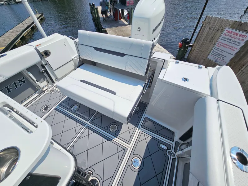 Slide: The Image of 2021 Blackfin 252 CC boat interior with seating and modern design at a dock. - 10