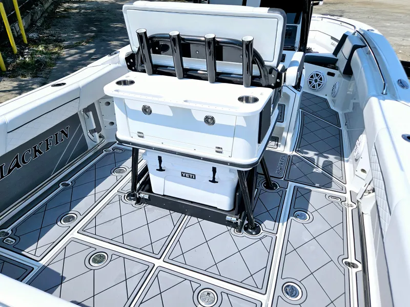 Slide: The Image of 2021 Blackfin 252 CC boat interior with fishing rod holders and non-slip deck. - 11