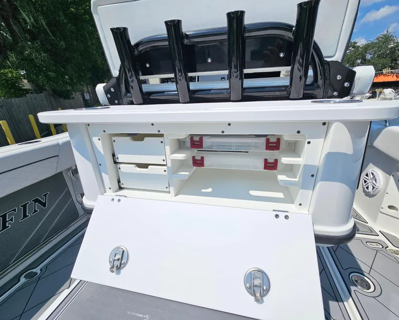 Slide: The Image of 2021 Blackfin 252 CC boat storage compartment with rod holders and open hatch. - 12